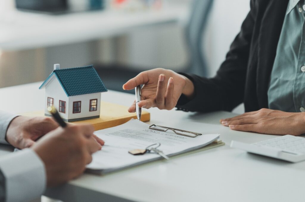 Close up Business woman or Real Estate agent explain signing agreement for buying house. Bank manager and real estate concept.